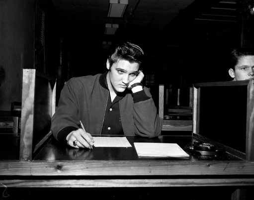 Singer Elvis Presley, 21, takes his pre-induction written examination as he is processed for the U.S. Army in Memphis, Tenn., Jan. 4, 1957. (AP Photo)