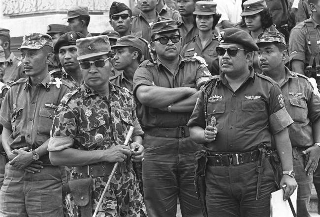 Maj. Gen. Suharto, 2nd left with sunglasses, is shown in this Oct. 6, 1965 file photo. Former dictator Suharto, an army general who crushed Indonesia's communist movement and pushed aside the country's founding father to usher in 32 years of tough rule that saw up to a million political opponents killed, died Sunday January 27, 2008. He was 86. (AP Photo, File)