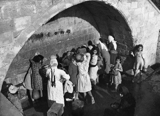 Arab women and children draw water from Mary’ well in Nazareth, Israel on Dec. 7, 1946, the ancient spring which legend relates supplies water for Mary. Joseph and Jesus.