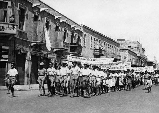 Great civil disturbances, eventually quelled by police and troops, developed from the Jewish demonstration against the British plan for the future of Palestine. In Jerusalem and other cities of Palestine, one constable was killed. Jewish youths leading the parade from which the trouble began. The Jewish flag they carry in Jerusalem, Israel on May 18, 1939. (AP Photo)