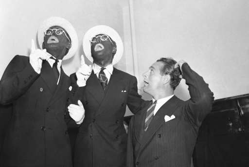 Among the stars of stage, screen and radio who appeared in New York's Madison Square Garden in a benefit performance for the relief of persecuted European Jews who wish to settle in Palestine, were Eddie Cantor, left, George Jessel, in blackface makeup, Nov. 17, 1938. They are joined by New York Yankees "Ironman" Lou Gehrig, who scratches his head.