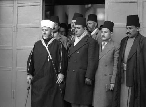 The Mufti of Jerusalem appeared before the Royal Palestine commission on January 12 as the first spokesman for the Arab Case. For two months the Arab higher committee, headed by the Mufti, declined to co-operate with the commission. The decision to testify came after the Arab sovereigns of Iraq and Saudi Arabia and appeared to the committee to appear before the commission. The Mufti (left) leaving the offices of the commission after his testimony on Jan. 12, 1937.