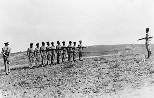 Due to the continued hostilities of the arabs in Palestine, Jewish police are being trained by British officers and given military training. A Jewish police corporal, right, training Jewish police recruits, under ther eye of a British officer, left, on July 30, 1936. (AP Photo)