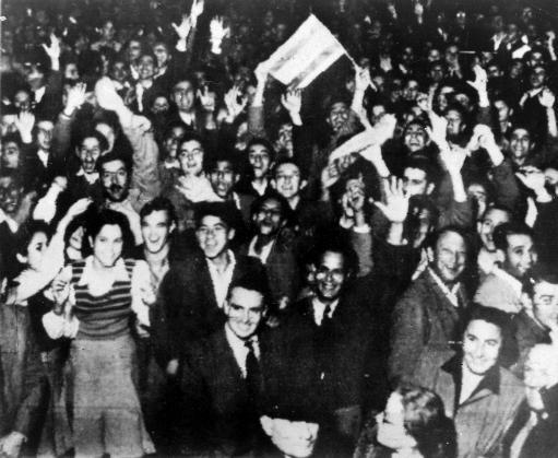 Jewish residents wave jubilantly in the streets in Tel Aviv, Israel. Celebrations began after the United Nations voted to partition Palestine into separate Jewish and Arab states.