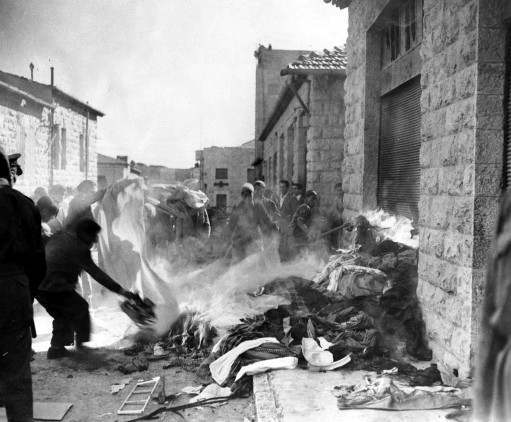 A crowd of arab demonstrators burn goods taken from Jewish homes in Jerusalem, Dec. 6, 1947, during the disturbances which broke out as the arabs staged a three-day strike against the partition plan. Jewish shops and homes in the quarter were attacked and some set on fire.