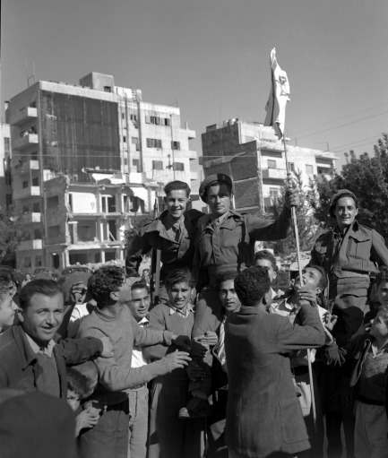 Jews who have been the enemies of the British for the past few years, have made up after hearing of the news of the declaration of the new Jewish State of Israel. Jews are seen hoisting British soldiers on their shoulders and holding the Israeli flag on Nov. 30, 1947 in Jerusalem. 