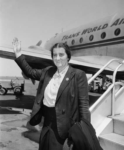 Mrs. Golda Meir is the only female member of the provisional council of the new state of Israel, waves following her arrival at La Guardia Field, New York, May 19, 1948 from Jerusalem. She declared that "if the United state arms embargo is lifted, we can drive the Arabs out in a few weeks." She added that the Jewish people in Palestine were optimistic of the successful outcome of the war because finances and manpower have been solidly mobilized. 