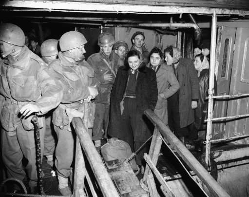 Young Jewish girls ready to leave the ?Heruth? at Haifa, Israel, on Feb. 16, 1947. Refugees were in very good humor and while waiting to land for the transshipment to Cyprus, spent their time talking to the soldiers of the 6th Airbourne Division.