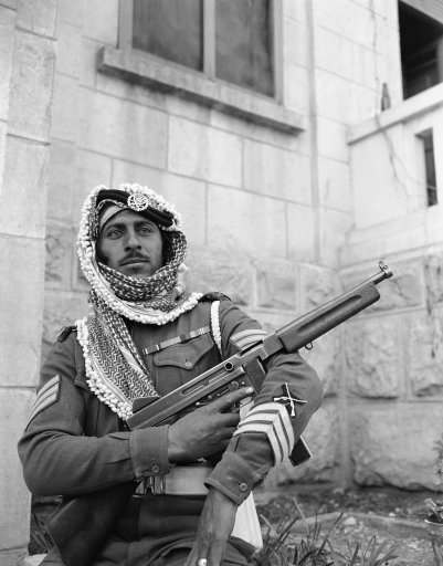 An Arab legion soldier fingers a machine gun as he stands guard in Jerusalem on Jan. 6, 1948 where his army is on loan to the British army to help out because of shortage of British soldiers in the holy land. (