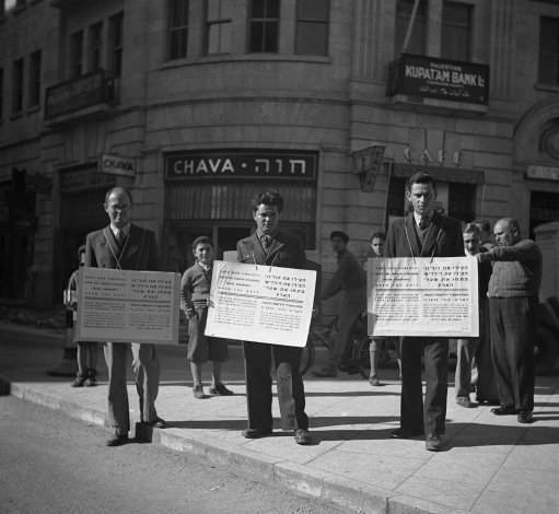 Save our children and our parents! say these Jewish placards carried by men in the streets of Jerusalem, Israel on Jan. 16, 1939. Open the gates of Palestine to the times of Nazi prevention hatred at the Christmas period we are crying from the holy city of Jew Salem to all Christian nations to help us against Germany. 