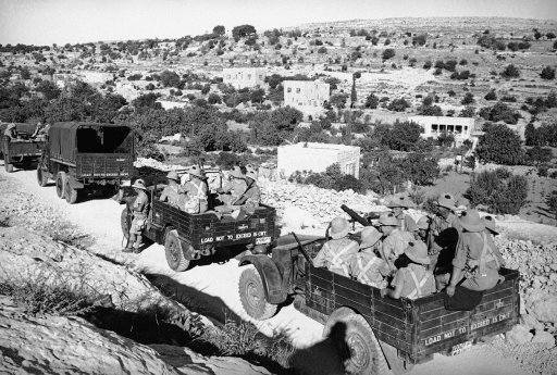 War trucks filled with fully armed British soldiers are shown on the road to ancient Hebron, city of the holy land, Israel on Sept. 5, 1938, where radial religious strife threatened to destroy the Biblical town. The town was sacked by Rebel Arabs, the driver of a British tank was slain and buildings were burned in the cut break which brought these motor lorries dashing to the terror torn city.