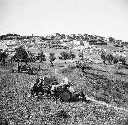 British troops, reinforced by new arrivals are concentrating on the Galilee area north Palestine, in the General hunt for Arab rebels on Jan. 11, 1938. New rubber tired British 3.75 howitzers bombarding rebels in the Galilee (north Palestine) area. 