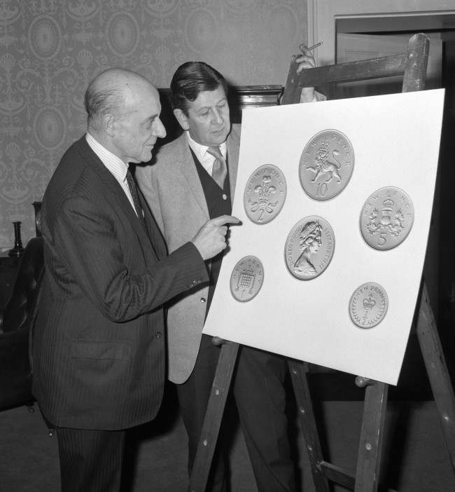 John Hastings James, Deputy Master and Comptroller of the Royal Mint, discussing the new decimal coinage with Christopher Ironside (right) who designed the reverses. Date: 15/02/1968