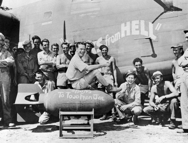 Film actor Joe E. Brown autographs a 1,000-pound bomb, 'To Tojo from Joe,' and says, ÂThere, boys, is the address with U.S. forces somewhere in New Guinea on April 15, 1943. Now go and deliver it. He is with the crew of the heavy B-24 bomber which is named Yanks from Hell.' (AP Photo)