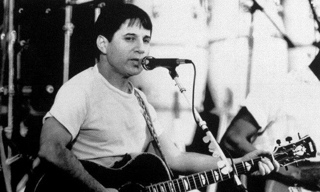 American singer Paul Simon performs for 20,000 fans in an open air stadium in Harare, Zimbabwe on Feb. 14, 1987, the first day of a two-day ÂGraceland in Concert event by Simon and 25 black South African musicians. It was Simon's first public performance in Africa of his Graceland album which blends African rhythms with American pop music. (AP Photo)