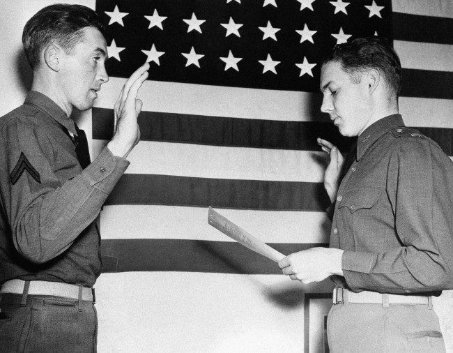 Lieut. E.L. Reid, personnel officer of the west coast training center at Moffett Field, California, right, swears in Jimmy Stewart, former movie star, as a second lieutenant in the Air Corps on Jan. 1, 1941. Stewart, who was one of HollywoodÂs most popular actors before he was inducted into the Army in 1941, was a corporal. (AP Photo)