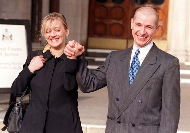 Former Royal Marine Graham Pearson and his wife, Rose, smile and clasp hands in celebration after the High Court awarded Mr Pearson 57,000 in compensation for stress that he has suffered as a result of helping victims aboard the wreck of the British Midland jet that crashed on the M1 at Kegworth in 1989 with the loss of 47 lives, today (Monday). See PA Story COURTS Kegworth. Photo by Michael Stephens/PA. Date: 09/02/1998