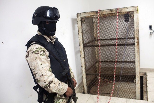 A Mexican army soldier stands next to an elevator shaft that lowers into a tunnel in the northern border city of Tijuana, Mexico Wednesday Nov. 30, 2011. U.S. authorities said they discovered a new cross-border tunnel Tuesday, the latest in a spate of secret passages found to smuggle drugs from Mexico. The tunnel was found in San Diego's Otay Mesa area, a warehouse district across the border from Tijuana, said Lauren Mack, a spokeswoman for U.S. Immigration and Customs Enforcement. (AP Photo/Alex Cossio)