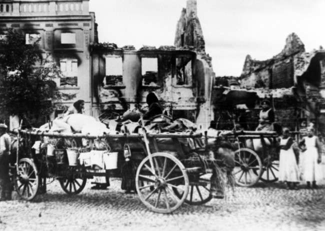 Civilians with their portable possessions loaded on wagons, in the ruins of a town destructed in the first sweep of the Czar's armies into German territory in an undated photo. (AP Photo)