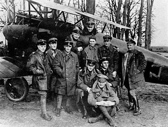 Baron Manfred Freiherr Von Richthofen sits in the cockpit of his Albatros fighter for a photograph with his squadron, Jagdstaffel III. Richthofen was credited with downing 80 Allied aircraft before being shot down over the Somme, Northern France, during what was known by pilots on both sides as 'Bloody' April, 1917. Manfred's brother, Lothar, is seated at front (fur collar).