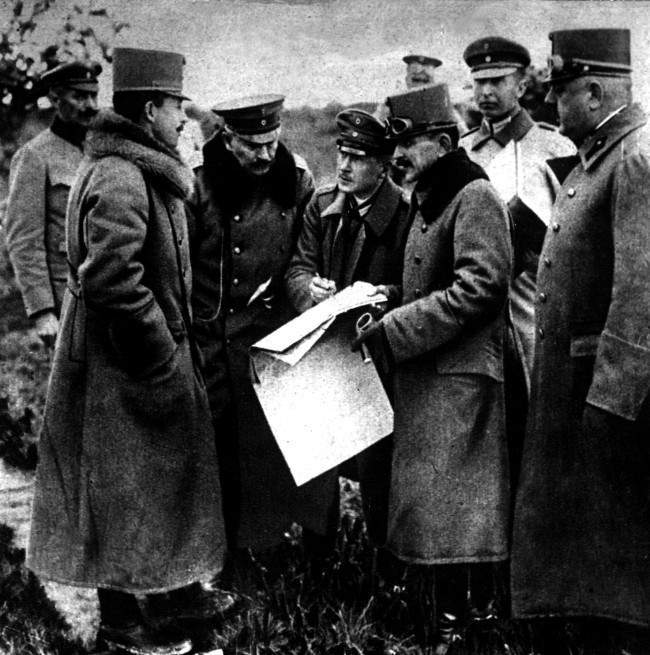 1918: The German Kaiser (3rd left) and the Emperor of Austria (2nd left) studying a map of Northern Italy during a visit to the Italian Front. 