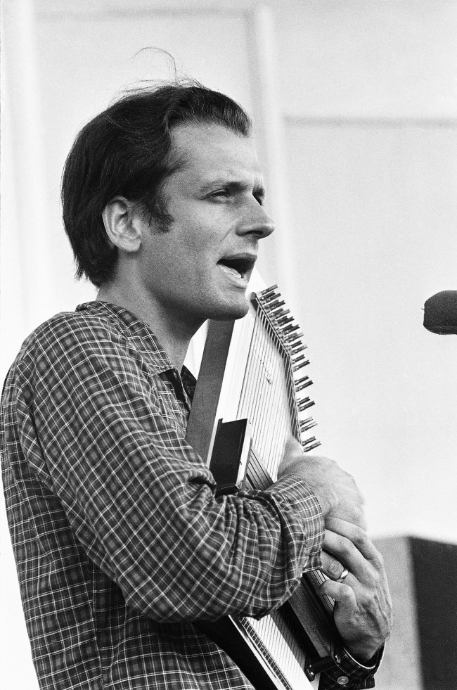 Mike Seeger, folk singer and auto-harp player as he entertained children on Children's Day at the Newport Folk Festival on July 20, 1966. The special programs were designed especially for children. Mike Seeger is a half-brother of famed folk singer Pete Seeger and a founding member of the folk group "The New Lost City Ramblers". (AP Photo/J. Walter Green) 