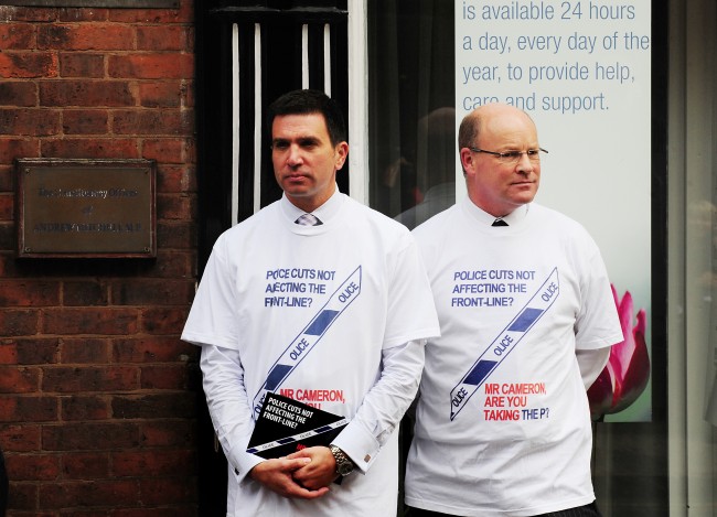 West Midlands police officers outside the constituency cffices of MP Andrew Mitchell, for the launch of a poster campaign against police cuts, in Sutton Coldfield, West Midlands. Picture date: Wednesday September 26, 2012.