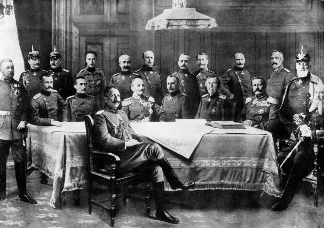 Kaiser Wilhelm II surrounded by his general staff. Standing (from left to right): Bulow, Mackensen, Molkte, Crown Prince Wilhelm, General Francois, Lumenoff, Falkennayn, Einem, Baseler, Chancellor Bathmann Hollweg, Heringen. Seated (from left to right): Crown Prince of Bavaria, Duke Wurtemburg, General Kluck, Emmich, Haeseler, Hindenburg, Admiral Tirpitz.