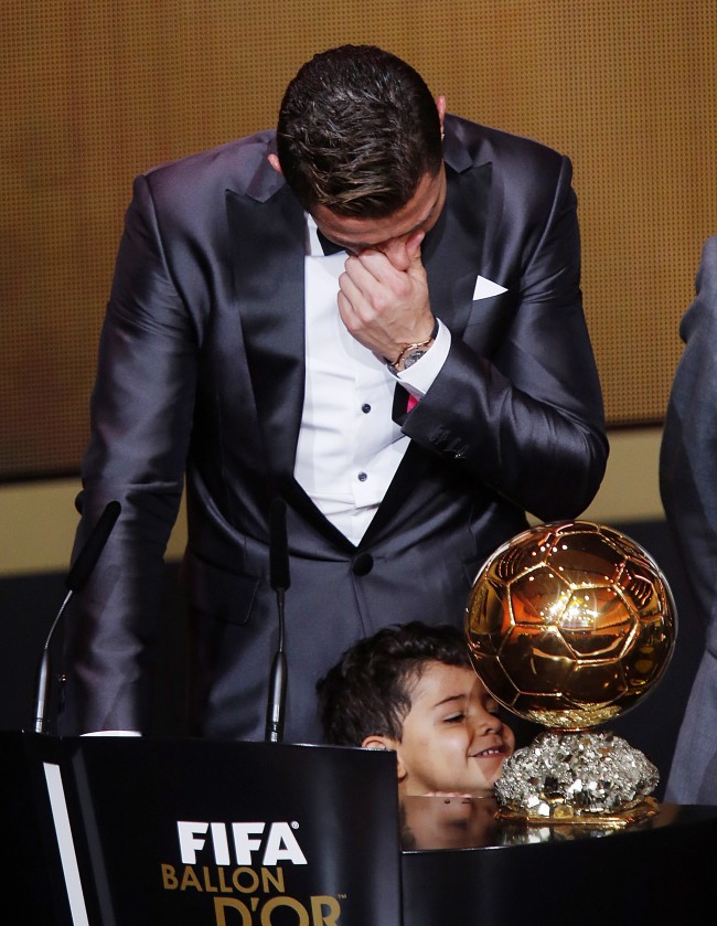 Real Madrid's Christiano Ronaldo of Portugal cries next to his son Ronaldo Junior after receiving the trophy for the world player at the FIFA Ballon d'Or 2013 Gala in Zurich, Switzerland, Monday, Jan. 13, 2014. 