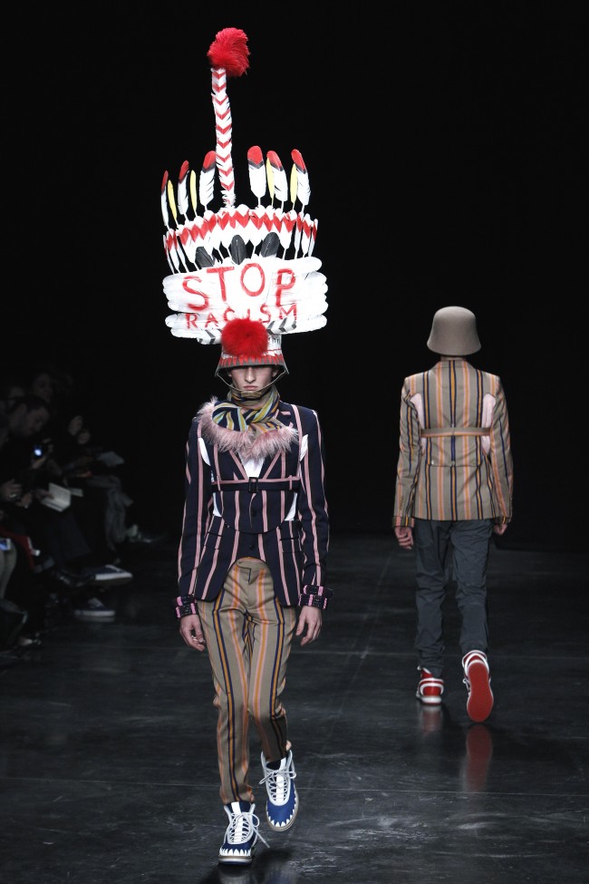 Models wear creations, including a headdress with the words Stop Rascism, by Dutch fashion designer Walter Van Beirendonck during his men's fall-winter 2014-2015 fashion collection presented in Paris, Wednesday, Jan.15, 2014. (AP Photo/Thibault Camus)
