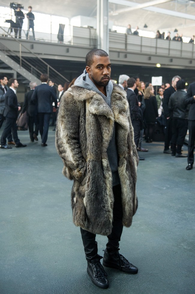 Singer Kanye West poses for photographers as he arrives to attend the Givenchy men's Fall-Winter 2014-2015 fashion collection, presented Friday, Jan. 17, 2014 in Paris. (AP Photo/Zacharie Scheurer)