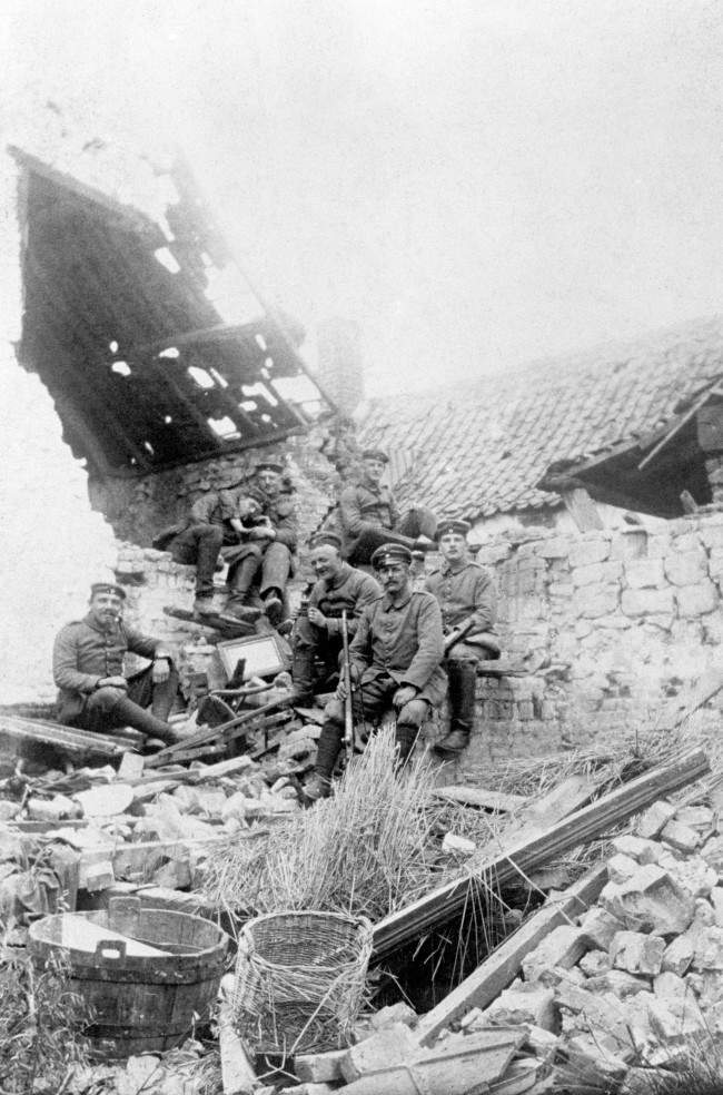 German troops relax in a ruined farmhouse during their occupation of Loos