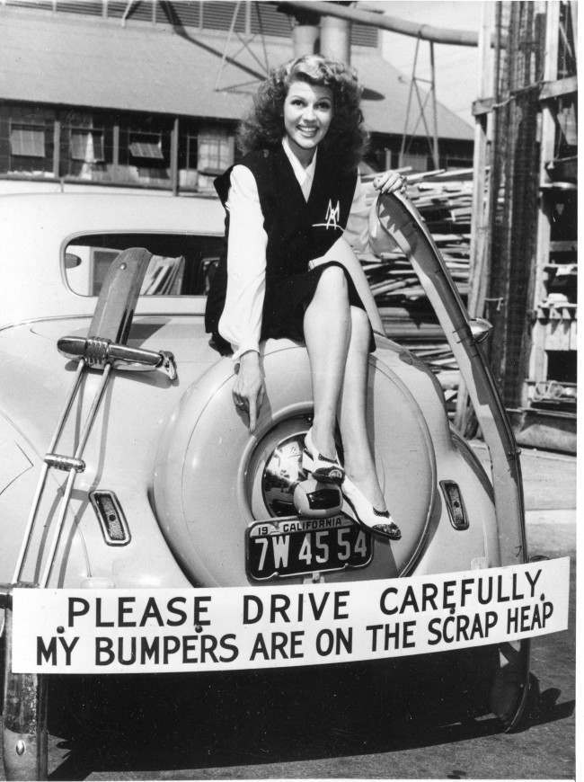 Actress Rita Hayworth participates in the scrap metal recycling campaign by donating her car's bumper in response to the call for bumpers and other non-essential metal car parts for the war effort in Hollywood. Hayworth has also been selling war bonds. 