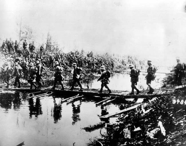 German troops pass over a temporary bridge at the western front in this undated photo during World War I. 