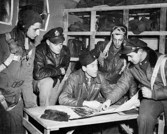 Major Jimmy Stewart talks over the final details of a mission with flyers about to take off, from left to right: Sgt. Keith M. Dibble of Rixford, Pa.; first Lt. Roger Counselman of Meadville, Pa.; Stewart; Sgt. Joseph T. Fiorentino of Philadelphia, Pa.; and second Lt. A.E. Lensky of Monessen, Pa., April 19, 1944, in England during World War II. (AP Photo)