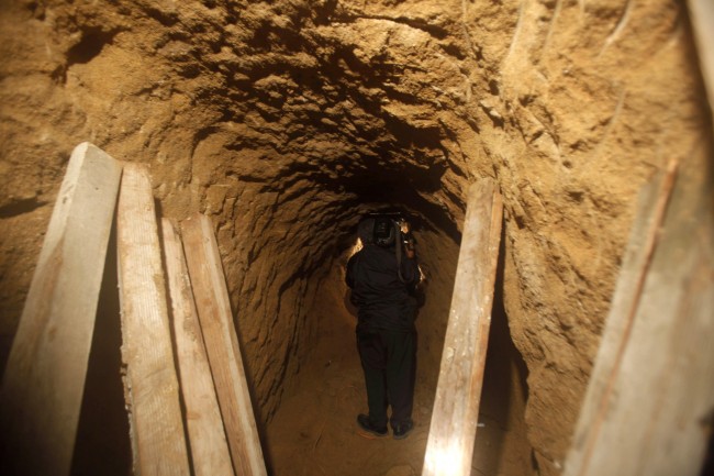 A cameraman takes footage inside a tunnel near the US-Mexico border in Tijuana, Mexico, Tuesday, Oct. 27, 2009. Mexican soldiers have discovered a secret tunnel complete with electricity and an air supply that may have been planned for smuggling migrants or drugs under the U.S. border into San Diego (AP Photo/Guillermo Arias)