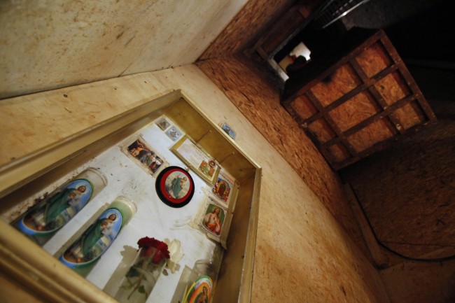 An altar is seen at the bottom of a 9 meters deep (29 feet), 122 meters long (400 ft) tunnel found by the Army on a house near the US-Mexico border in Tijuana, Mexico, Saturday, Nov. 7, 2009.(AP Photo/Guillermo Arias)