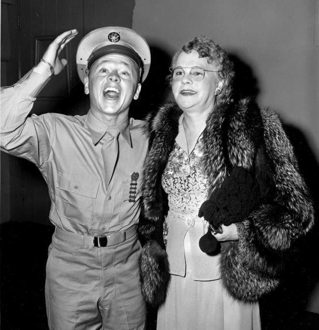 Pvt. Mickey Rooney attends a Hollywood movie premiere with his mother, Nell Pankey, on Aug. 17, 1944. The actor is back in Hollywood after completing three months of basic training at Fort Riley, Kansas. (AP Photo)