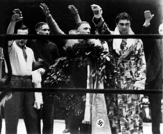 Max Schmeling, right, and his attendants give the Nazi salute in Hamburg, Germany, March 10, 1935. (AP Photo)