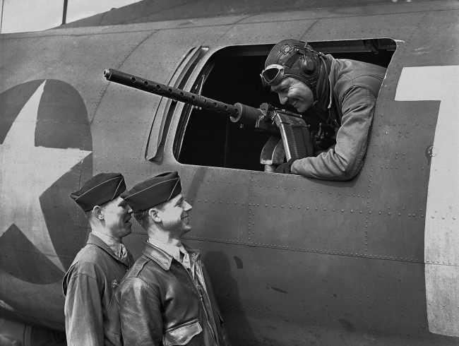 American film star Clark Gable at the waist gun position of his Flying Fortress, on an airfield somewhere in England on June 5, 1943, talking to Sergeant Gunner Kenneth Huls, left, and Sergeant Gunner Phillip Hulse. (AP Photo)