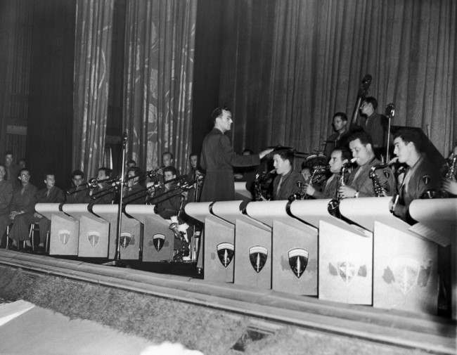 Capt. Glenn Miller, who has come to Britain with the American band of the Supreme Allied Command, gave Londoners a treat by appearing with his band at a gala premiere of the new Bing Crosby Film, ÂGoing My Way,Â at a West End Movie Theater in London, August 5, 1944. Proceeds from the premiere were used to aid LondonÂs Stage Door Canteen, soon to be opened. The band leader is leading is army band in a thirty-minute session of swing music during the stage door canteen benefit. (AP Photo)