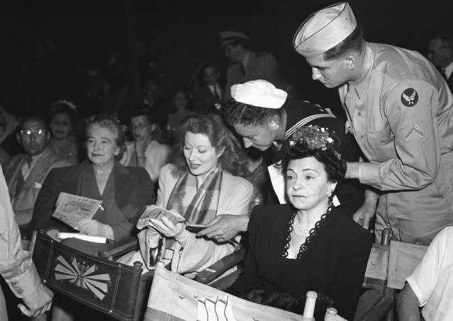 Service men keep Greer Garson, film star, pushing the autograph pencil at Orson WellesÂ big music show in Hollywood, Los Angeles, free to men in uniform, on August 9, 1943. (AP Photo)