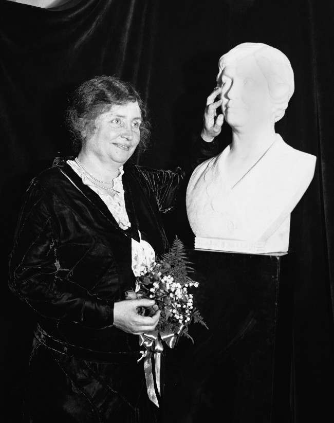 Miss Helen Keller, probably the most famous blind woman in the world, photographed in New York City on Oct. 29, 1931 with a bust of herself sculptured by count Hans-Albrecht Hafrach of Munich, Germany. The bust was presented to the American Foundation for the Blind by M.C. Migel, president of the American Foundation for the Blind, to pay a tribute to the work of Miss Keller for the organization.
