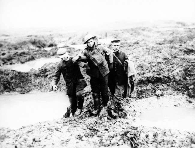 Canadian and German wounded help one another through the mud during the capture of Passchendaele in Belgium sometime between July and November 1917. (AP Photo)