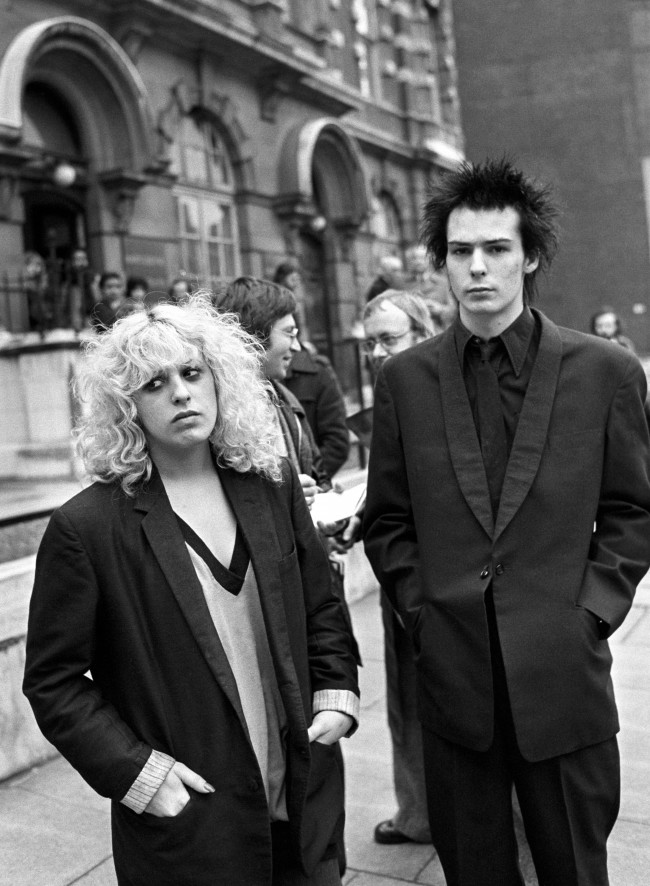 Sid Vicious, of punk rock group the Sex Pistols, with his girlfriend Nancy Spungen, outside Marylebone Magistrates court after being charged possessing the drug methamphetamine. Date: 08/02/1978