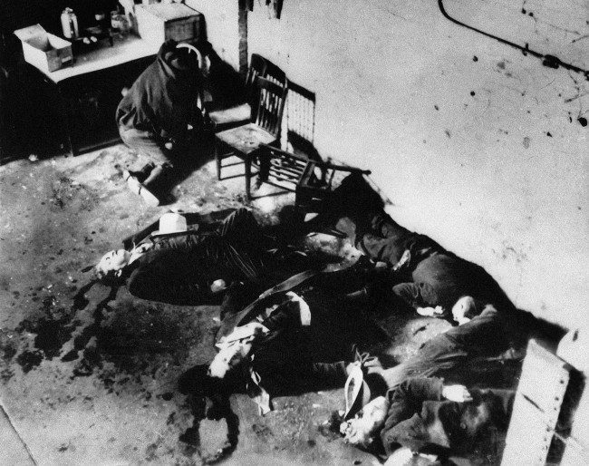 The bodies of six of the men who were slain in a gang-shooting in Chicago's North Side, Feb. 14, 1929. Several of the bodies are huddle together on the floor while another is slumped on chair at the extreme left. The seventh body was taken to the Alexian Brothers Hospital. (AP Photo)
