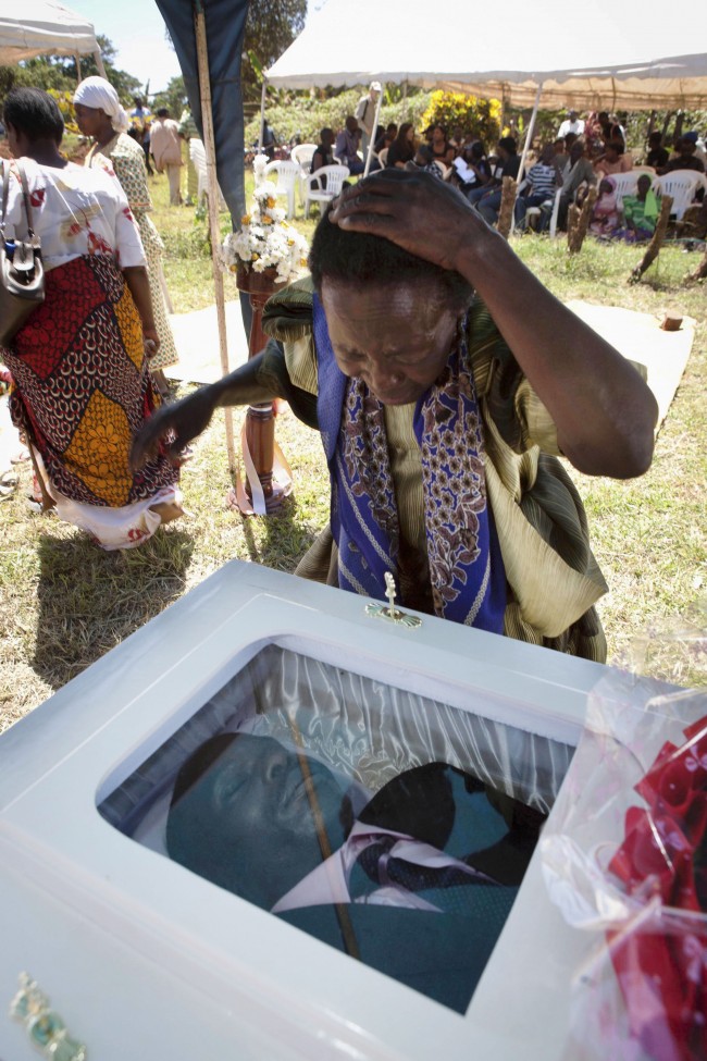  In this Friday, Jan. 28, 2011 file photo, a woman grieves at the coffin of gay activist David Kato in Mukono, Uganda. As a prominent Ugandan gay rights activist, his picture was published by an anti-gay newspaper next to the words "Hang Them." He was killed on Wednesday, Jan. 26, 2011. Police said Thursday his sexual orientation had nothing to do with the killing and that one "robber" had been arrested. Uganda has been under scrutiny by international gay-rights groups since 2009, when a lawmaker proposed a bill that would mandate the death penalty for some gay acts. 