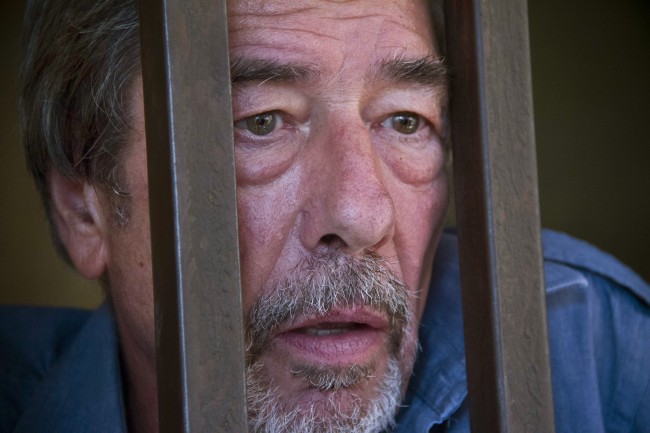 Briton Bernard Randall, 65, stands in a holding cell after a court hearing which ordered him to be deported, at the Chief Magistrates court in Entebbe, Uganda Wednesday, Jan. 22, 2014. A Ugandan court on Wednesday ordered the deportation of Randall who faced criminal charges following publication of images of him having sex with another man.