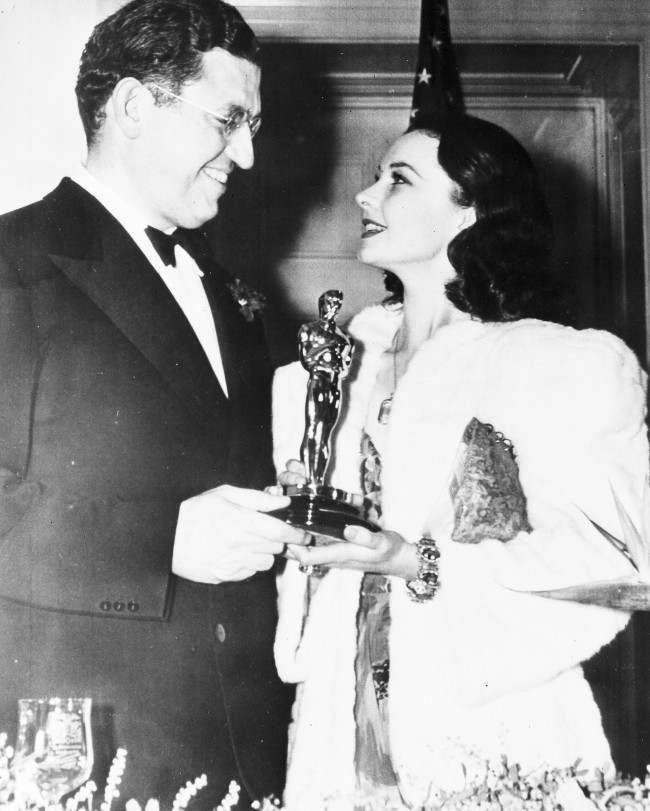 British actress Vivien Leigh, holding her Oscar, which she won for Best Actress for her role in the film "Gone With The Wind", talks to American film producer David O. Selznick, at the banquet of the Academy of Motion Pictures, Arts and Sciences, in Hollywood, Calif., on Feb. 29, 1940. Selznick also won a special award for the same film.