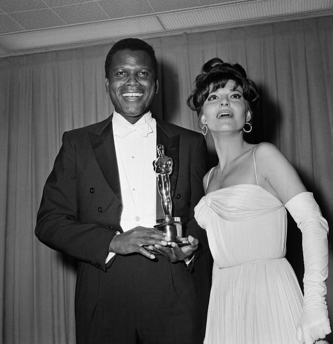 Sidney Poitier was named best actor of the year for 1964 for his role in "Lilies of the Field," awarded by actress Anne Bancroft, at right, at ceremonies in Santa Monica, Calif. on April 13, 1964. The award was presented by the Motion Picture Academy. 